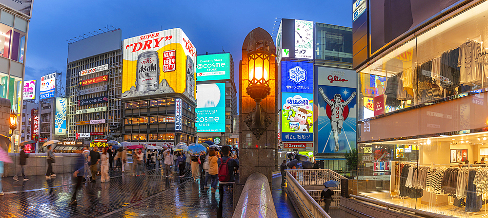 View of Glico sign of Dotonbori, vibrant entertainment district near the river at dusk, Osaka, Honshu, Japan, Asia