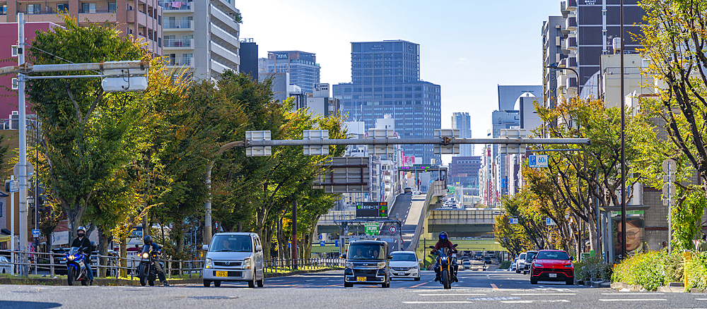 View of traffic and city skyline on Route 30 on a sunny day, Shitennoji, Tennoji Ward, Osaka, Honshu, Japan, Asia