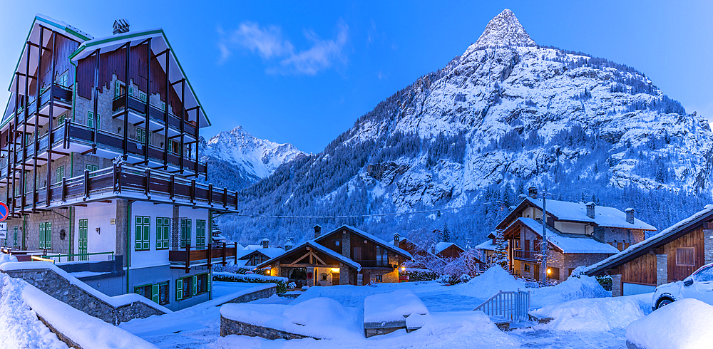 View of chalets and snow covered mountains in Courmayeur before dawn during winter, Courmayeur, Aosta Valley, Italy, Europe