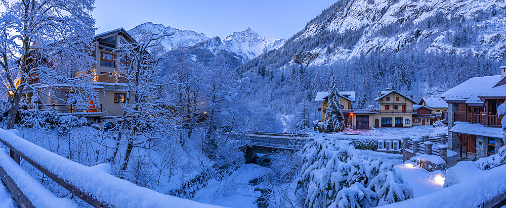 View of chalets and snow covered mountains in Courmayeur before dawn during winter, Courmayeur, Aosta Valley, Italy, Europe