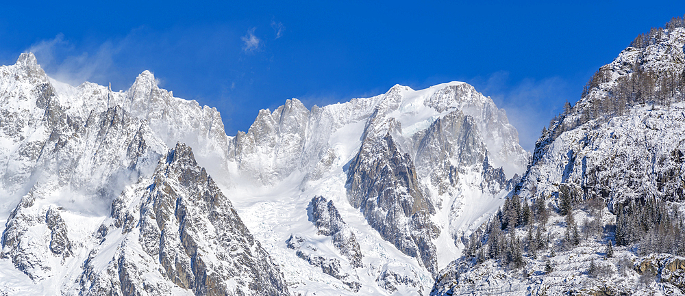 View of snow covered trees, mountains and Courmayeur from Dolonne during winter, Courmayeur, Aosta Valley, Italy, Europe