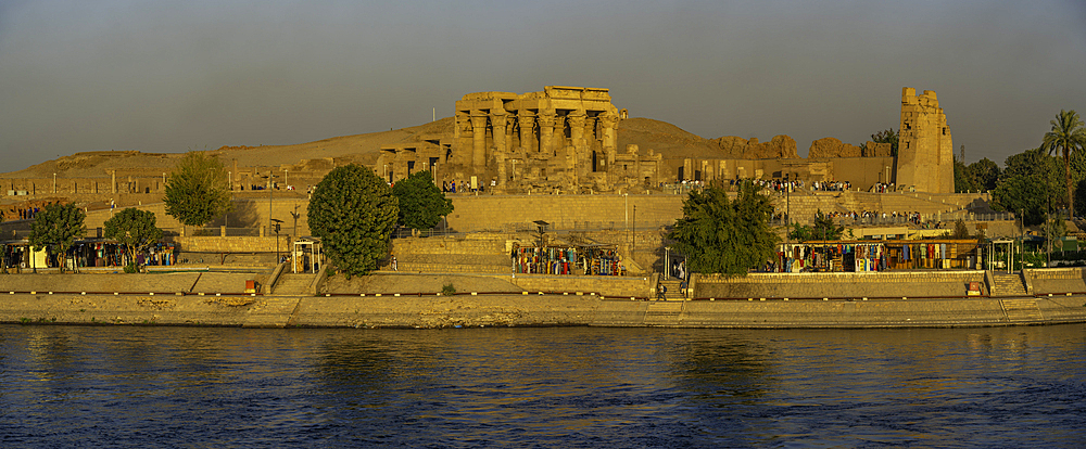 View of Kom Ombo Temple on the Nile river from cruise boat at sunset, Aswan, Nubia, Egypt, North Africa, Africa