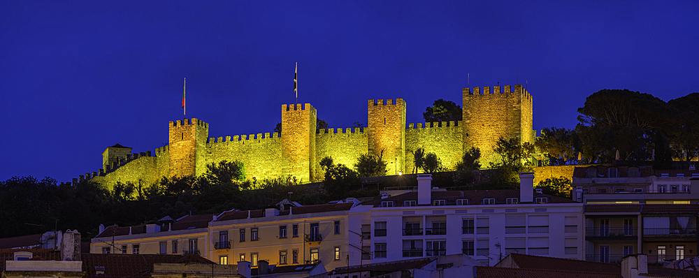 View of hilltop Castelo de São Jorge, (Lisbon Castle) illuminated at dusk, Lisbon, Portugal, Europe