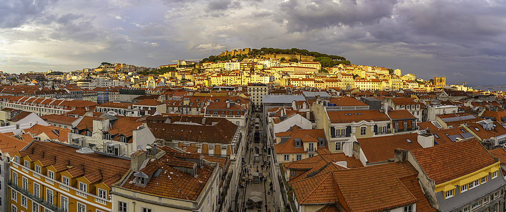 View of city rooftops and Lisbon Castle from Santa Justa Lift during golden hour, Lisbon, Portugal, Europe