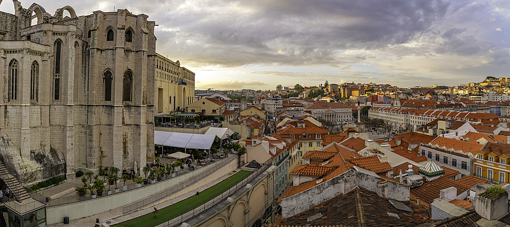 View of city rooftops and Carmo Archaeological Museum from Santa Justa Lift during golden hour, Lisbon, Portugal, Europe