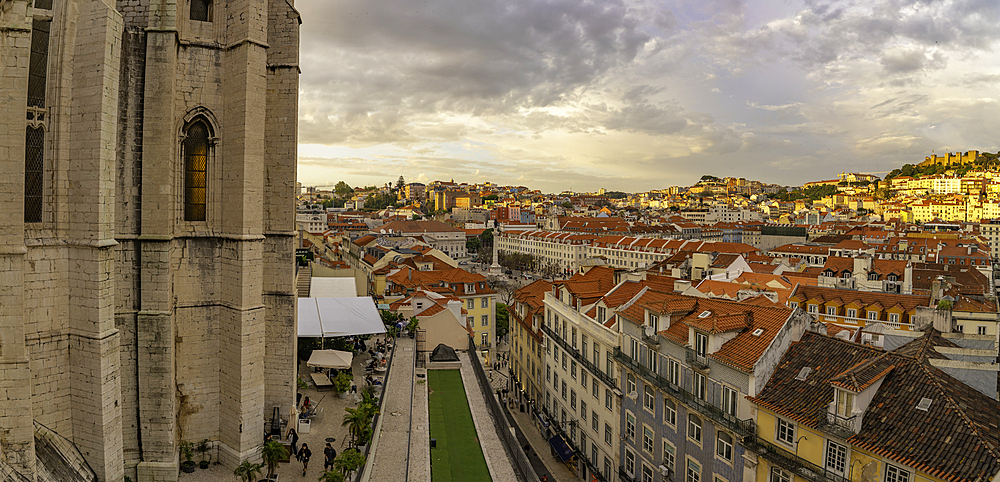 View of city rooftops and Carmo Archaeological Museum from Santa Justa Lift during golden hour, Lisbon, Portugal, Europe