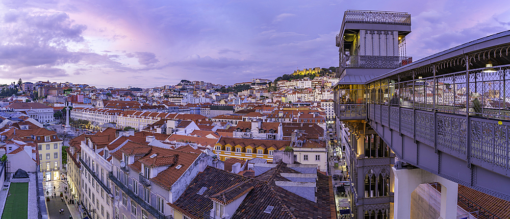 View of city rooftops and Santa Justa Lift from Carmo Archaeological Museum at dusk, Lisbon, Portugal, Europe