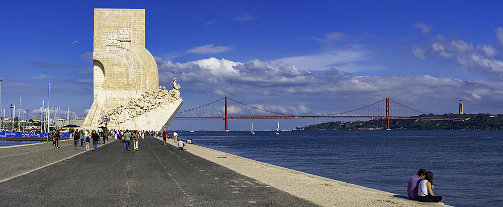 View of Monument to the Discoveries (Padrão dos Descobrimentos) and 25 April Bridge on a sunny day, Lisbon, Portugal, Europe