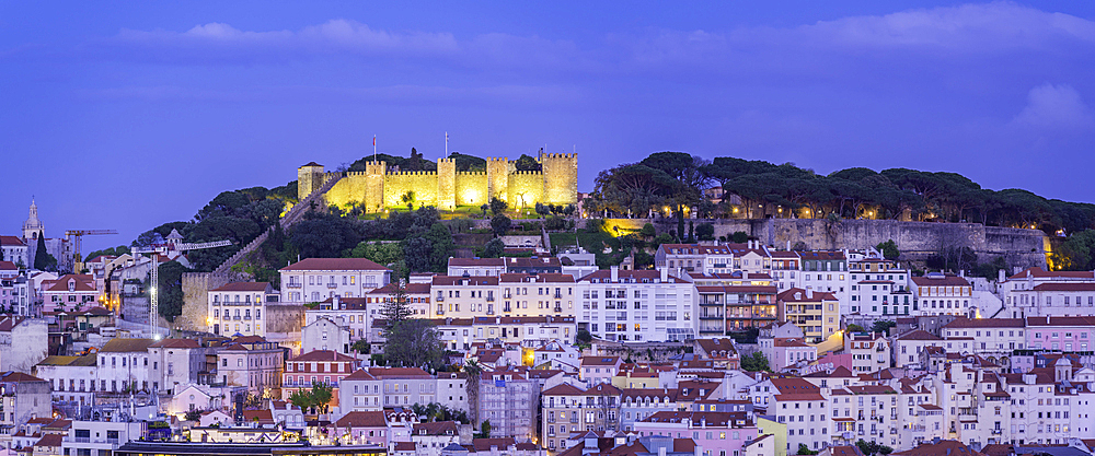 View of Lisbon Castle from Miradouro de Sao Pedro de Alcantara at dusk, Lisbon, Portugal, Europe