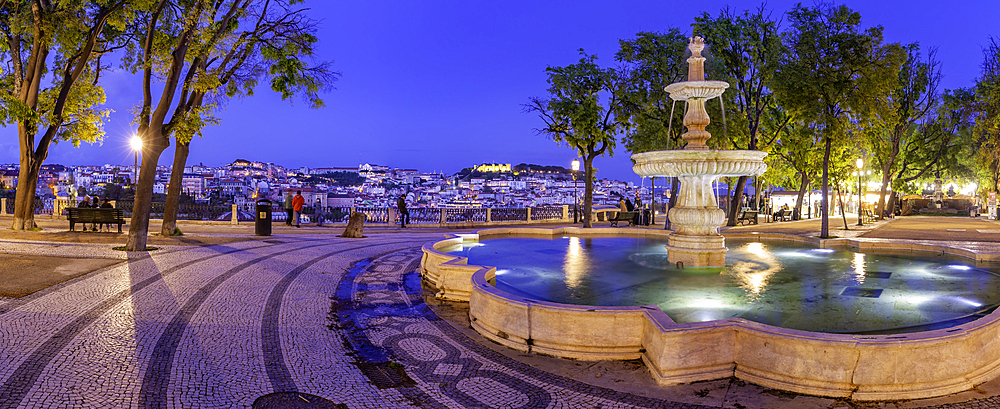 View of Lisbon and fountain in Miradouro de Sao Pedro de Alcantara at dusk, Lisbon, Portugal, Europe