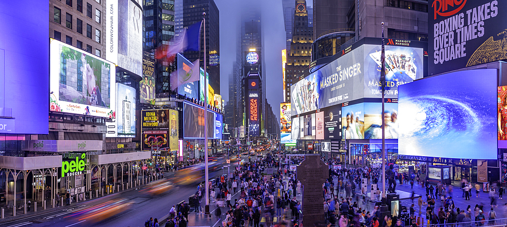 View of neon lights in Times Square at dusk, New York City, United States of America, North America