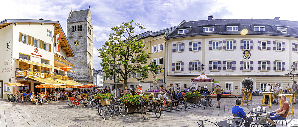 View of St. Hippolyte Church and cafe in Stadtplatz in Zell am See on a sunny day, Zell am See, Salzburg, Austria, Europe