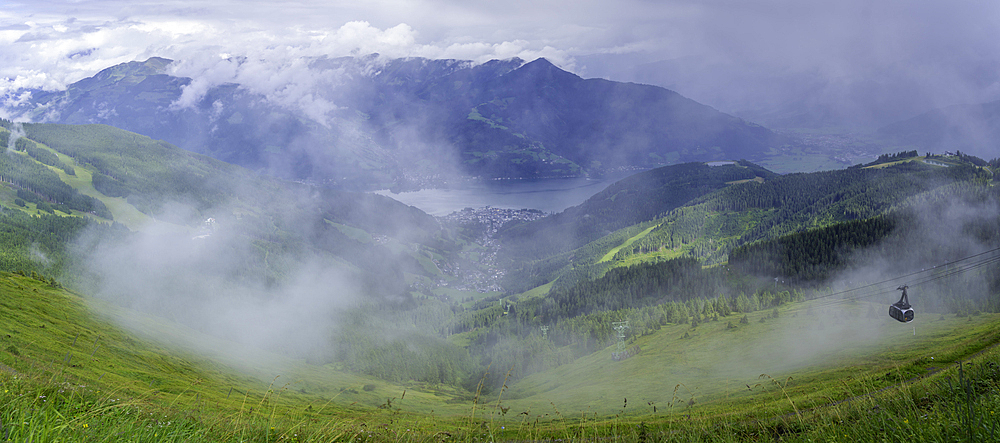 View of cable car, Zell am See and cloud from Schmittenhöhebahn top station 2000m on a sunny day, Zell am See, Salzburg, Austria, Europe