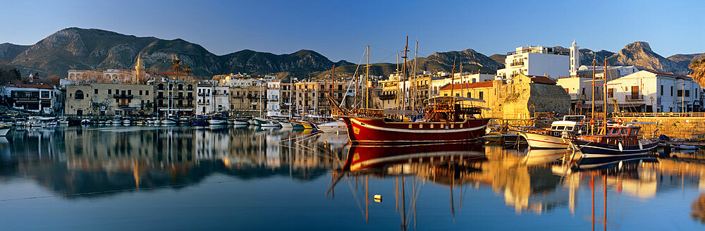 The boat filled harbour and mountains with mirror reflection, Kyrenia (Girne), Northern Cyprus, Cyprus, Mediterranean, Europe