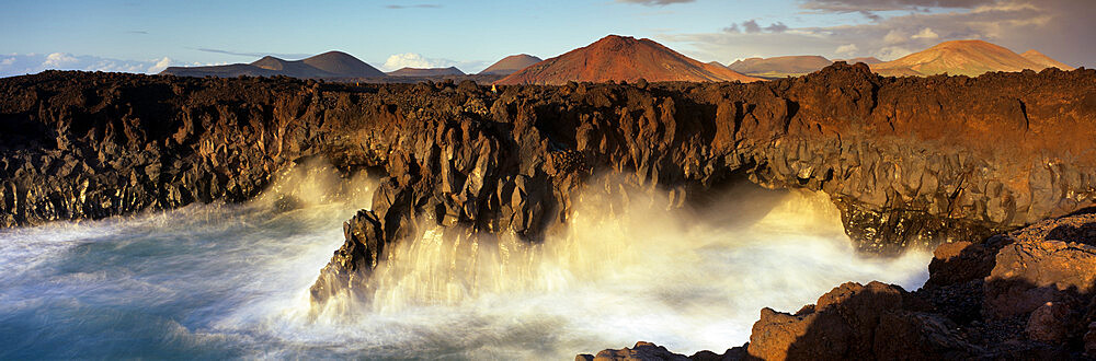 Volcanic coastline with waves crashing into sea caves, Los Hervideros, Timanfaya National Park, Lanzarote, Canary Islands, Spain, Atlantic, Europe