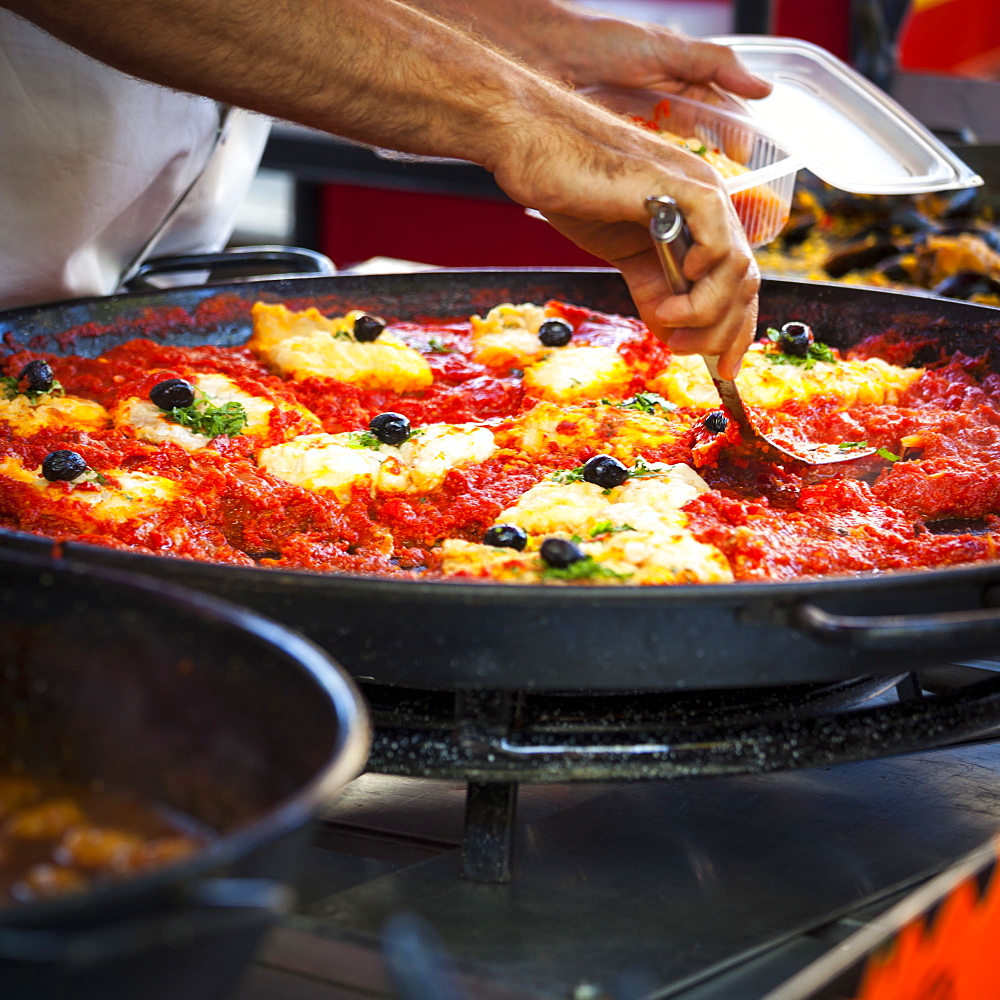 Man cooks Catalan cuisine in the Saturday market, Ceret, France, Europe