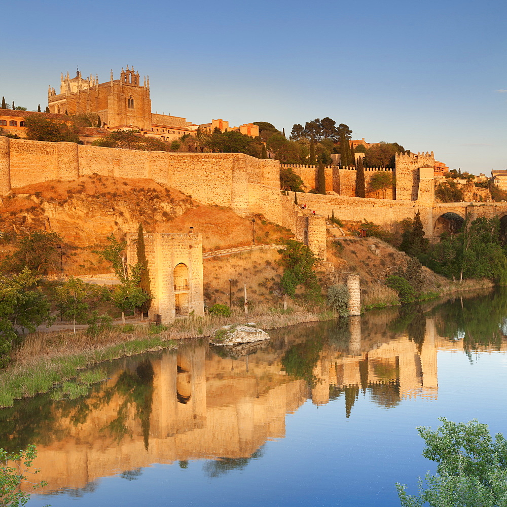 San Juan des los Reyes Monastery and town wall reflected in the Tajo River, Toledo, Castilla-La Mancha, Spain, Europe