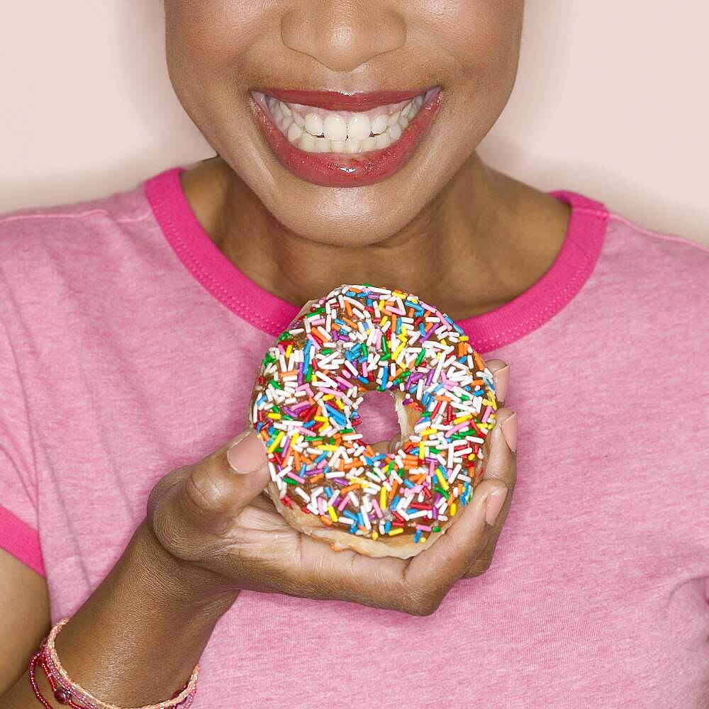 Close up of woman holding donut