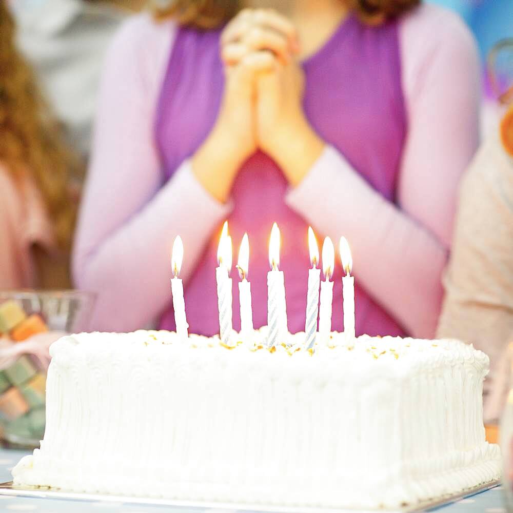 Close up of candles on birthday cake at party