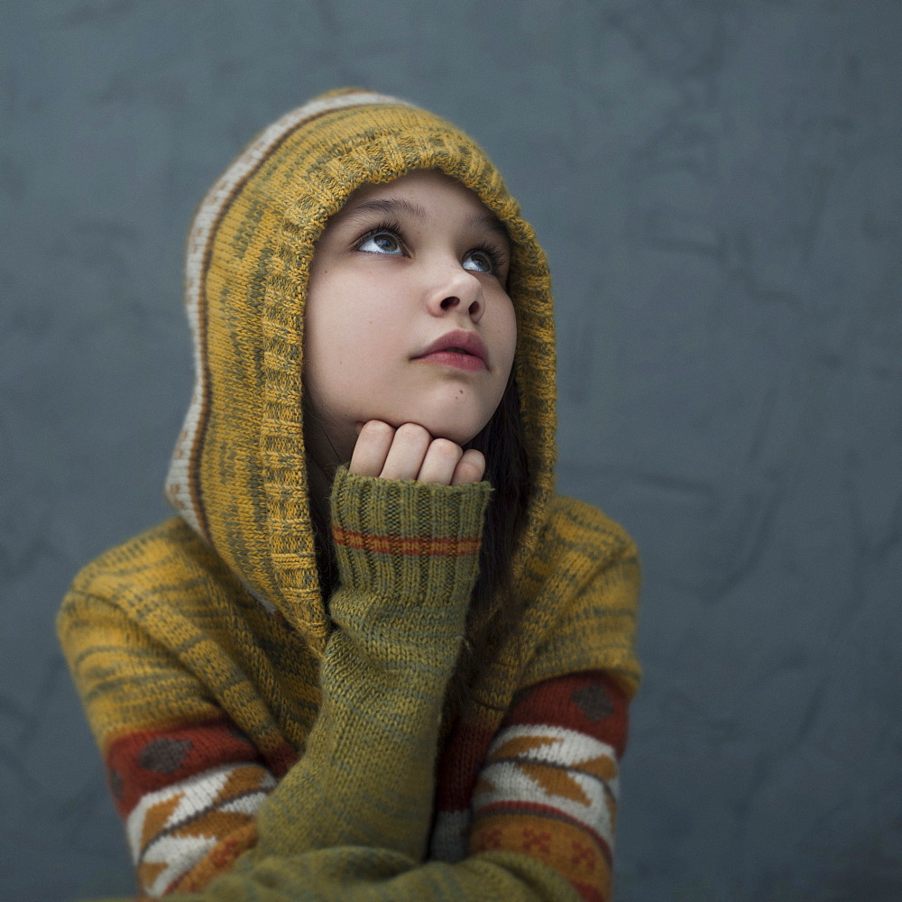 Pensive Caucasian girl wearing hood