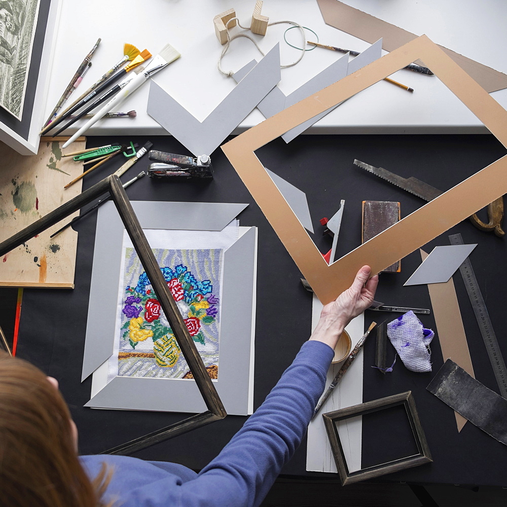 Caucasian woman holding mat for picture frame