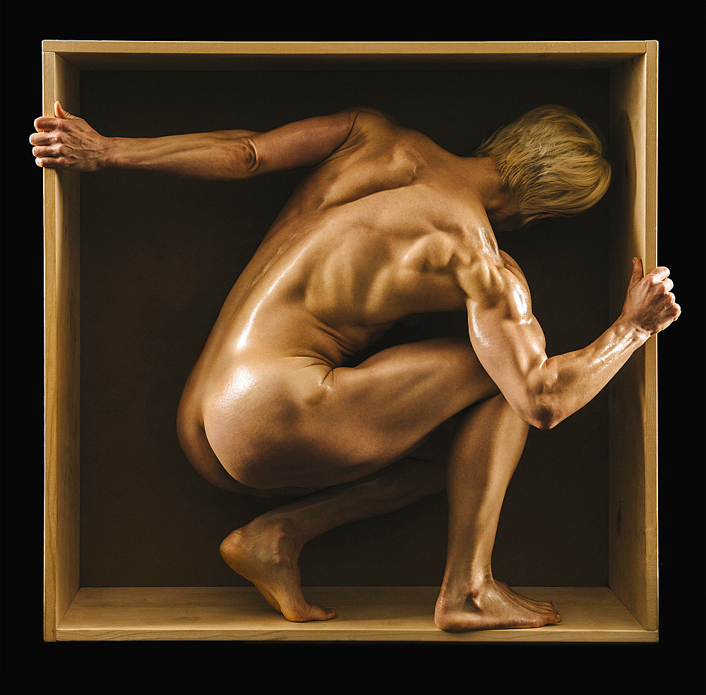 Muscular Caucasian woman crouching in box