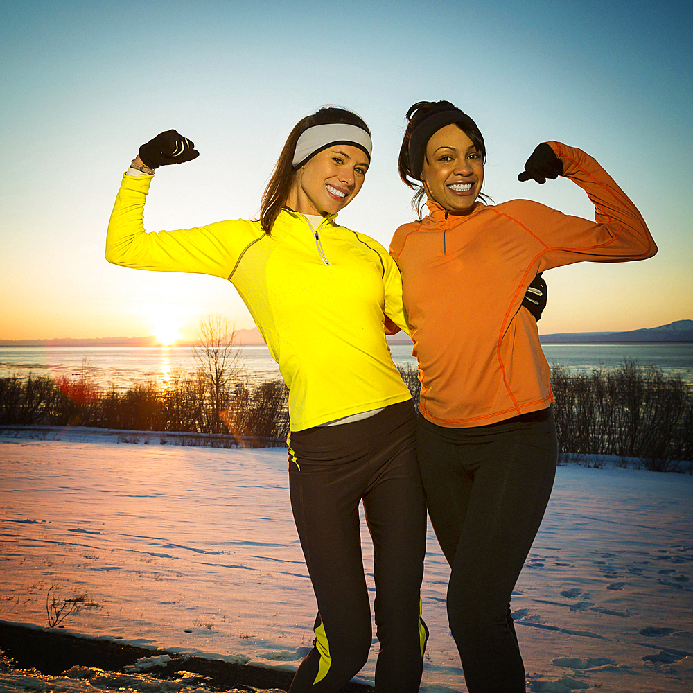 Runners posing and flexing muscles in winter