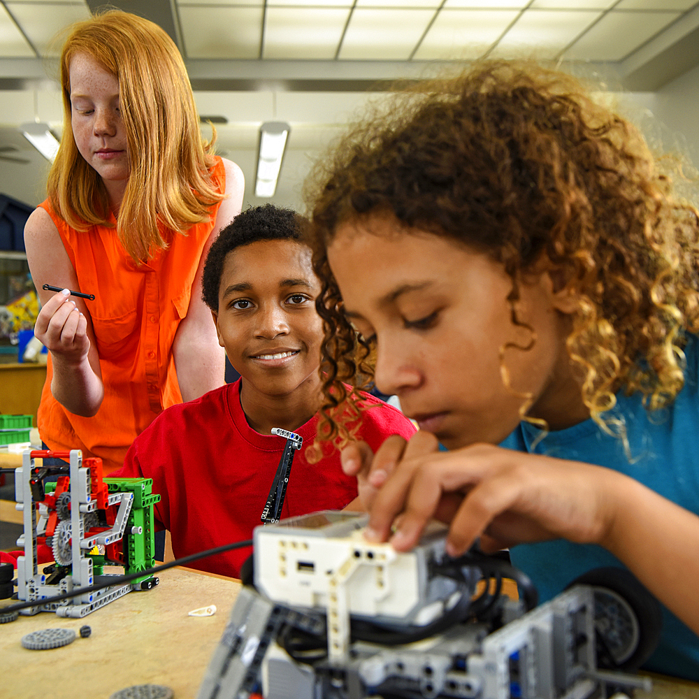 Students assembling plastic blocks in library