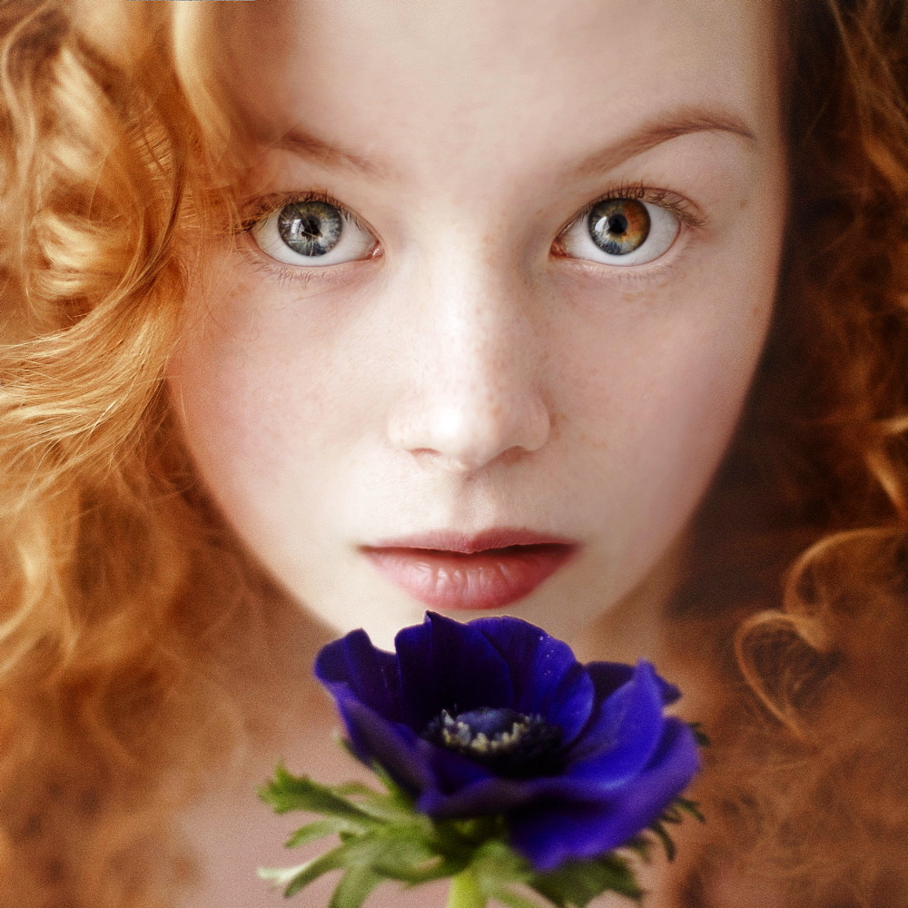 Caucasian teenage girl holding flower