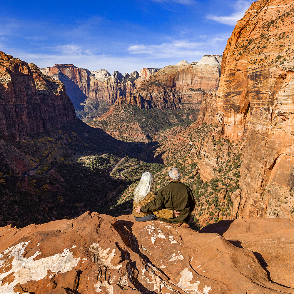 Rear view of senior couple looking at Zion Canyon from Zion Overlook