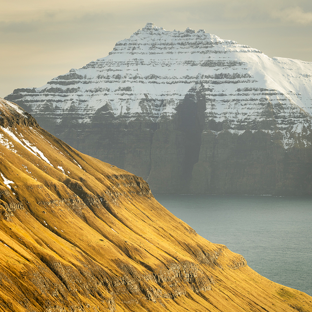 Snow-covered cliffs and mountains along Funningur fjord, Eysturoy Island, Faroe Islands, Denmark, Europe