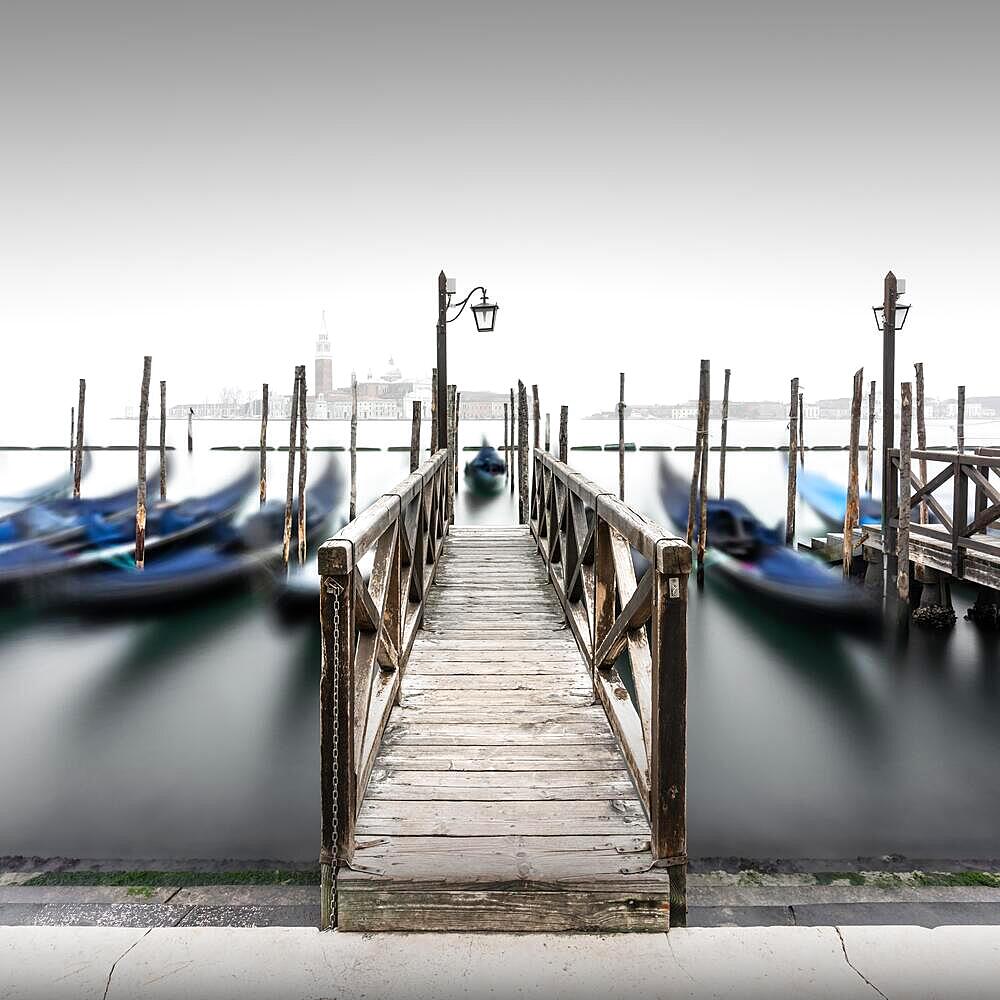 Minimalist long exposure of the gondolas at the Piazzetta near the Campanile at St. Mark's Square in Venice, Italy, Europe