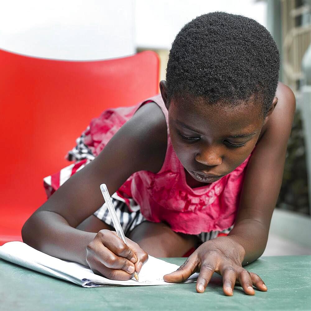 Medium shot girl writing notebook