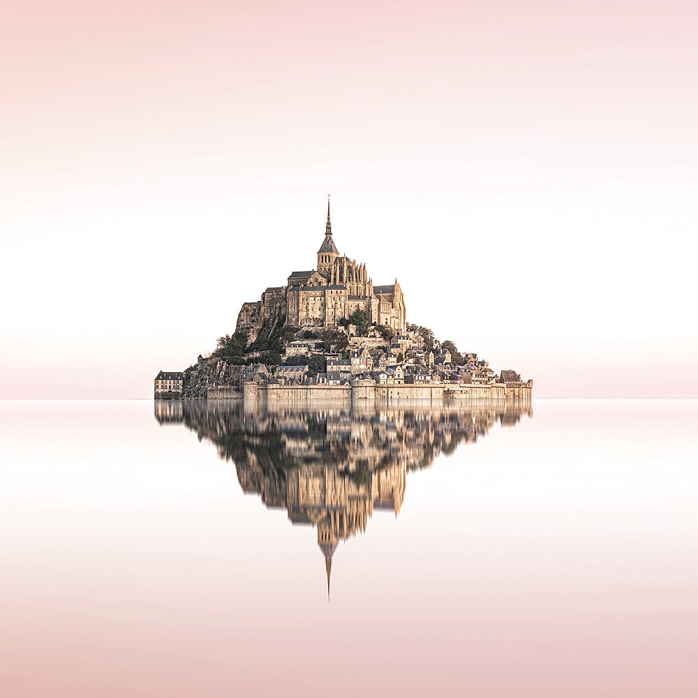 Perfect reflection of Mont Saint Michel, probably the most famous monastery mountain in the world, at sunrise. Mont Saint Michel, France, Europe