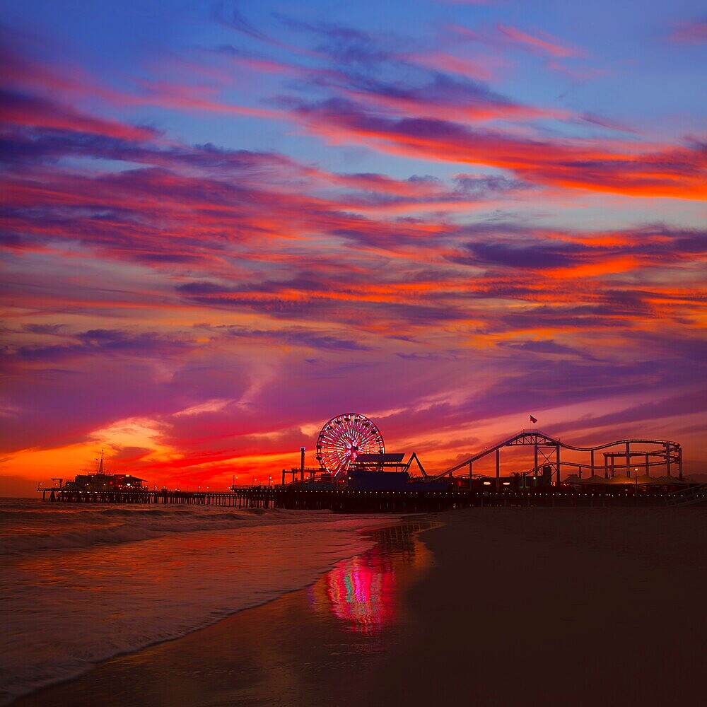 Santa Monica California sunset on Pier Ferrys wheel and reflection on beach wet sand