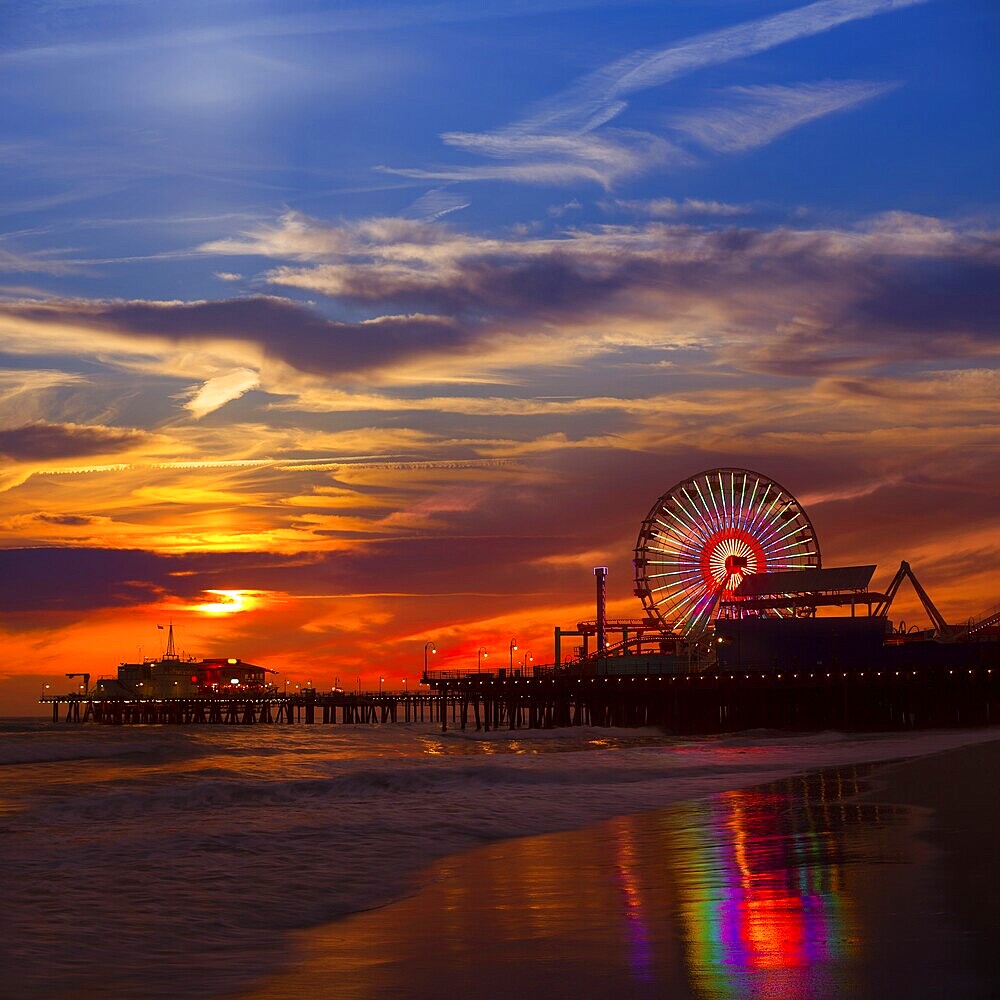 Santa Monica California sunset on Pier Ferrys wheel and reflection on beach wet sand