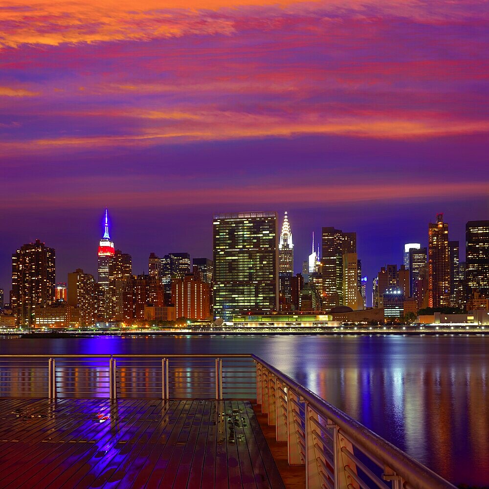 Manhattan New York skyline at sunset rainy dusk from East River NYC USA