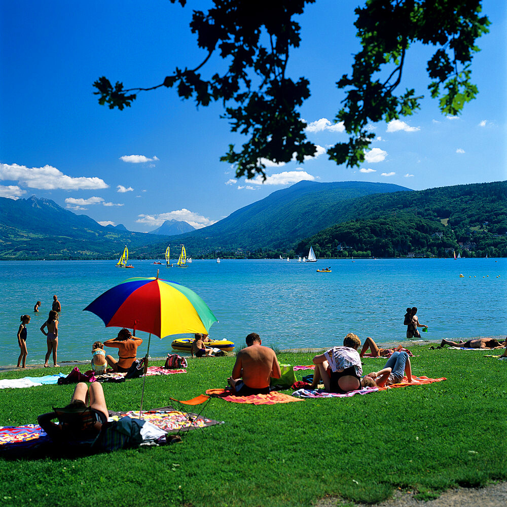 Sunbathers along shore of Lake, Annecy, Lake Annecy, Rhone Alpes, France, Europe