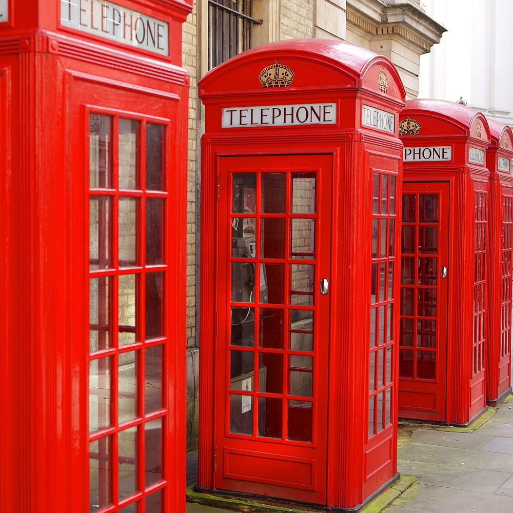 Row of red telephone booths design by Sir Giles Gilbert Scott, near Covent Garden, London, England, United Kingdom, Europe 