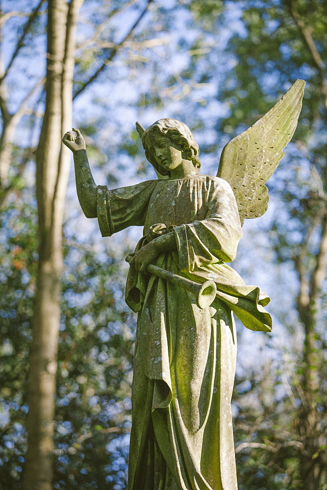 Statue of an angel with a trumpet, Highgate Cemetery west, London, England, United Kingdom, Europe