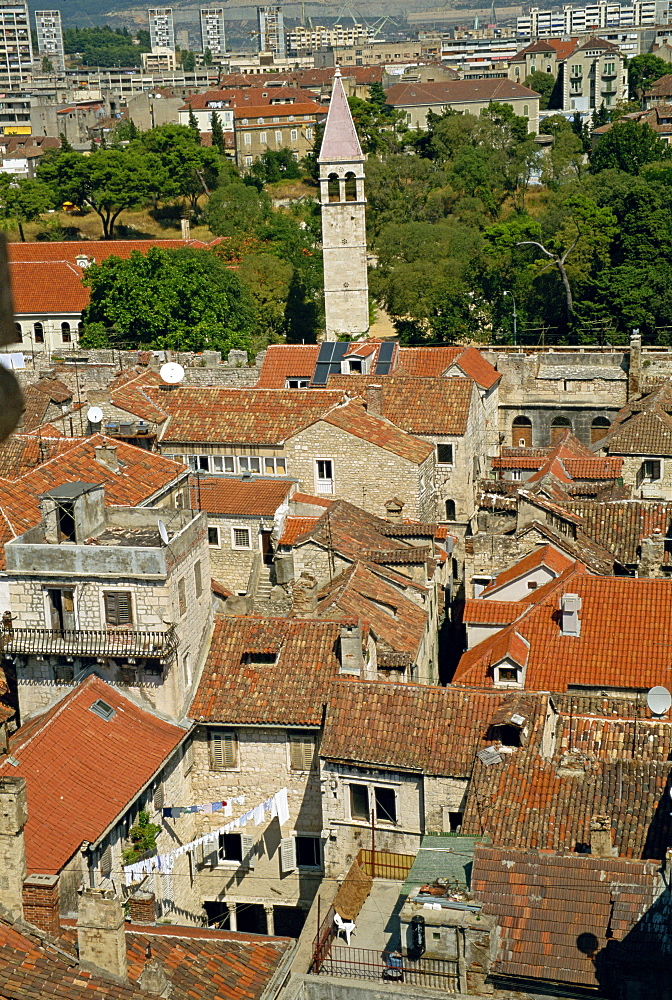 Skyline of houses with tile roofs and Diocletian's palace in old town, looking north to Golden Gate and modern blocks in distance in Split, Dalmatia, Croatia, Europe