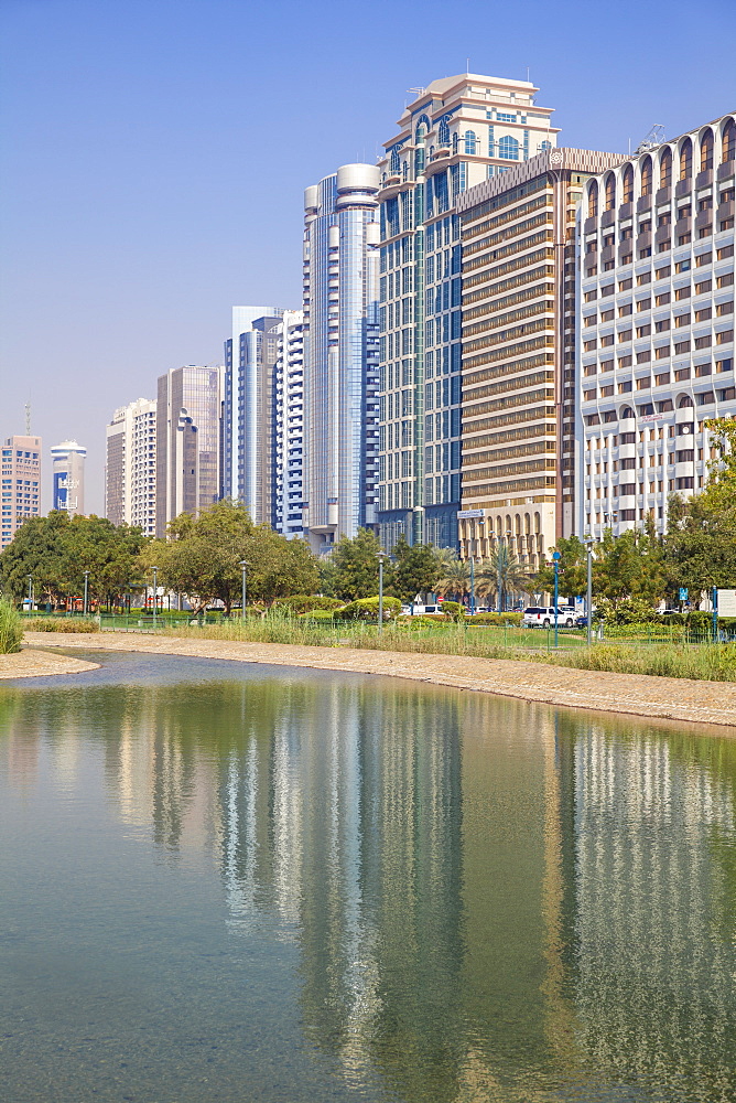 City Center buildings reflecting in Corniche Lake, Abu Dhabi, United Arab Emirates, Middle East