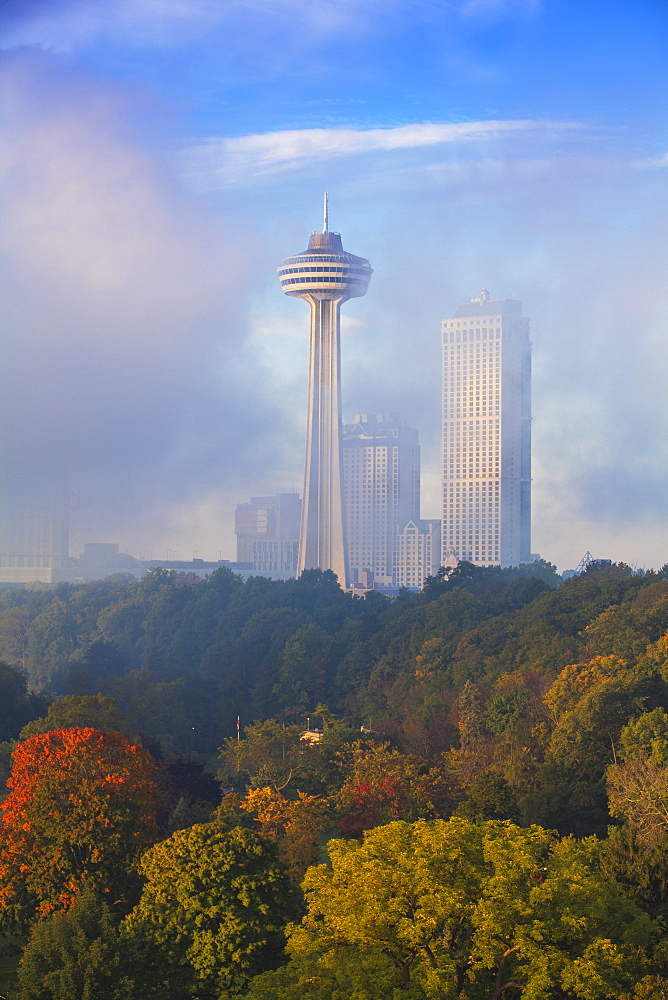 Mist from Horseshoe Falls swirling in front of Skylon Tower at dawn, Niagara Falls, Niagara, Ontario, Canada, North America