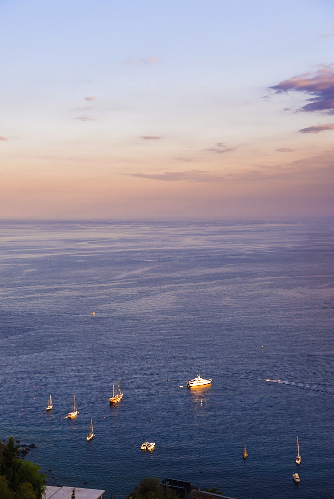 Boats at sunset on the Ionian Sea, part of the Mediterranean Sea, Taormina, East Coast of Sicily, Italy, Mediterranean, Europe 