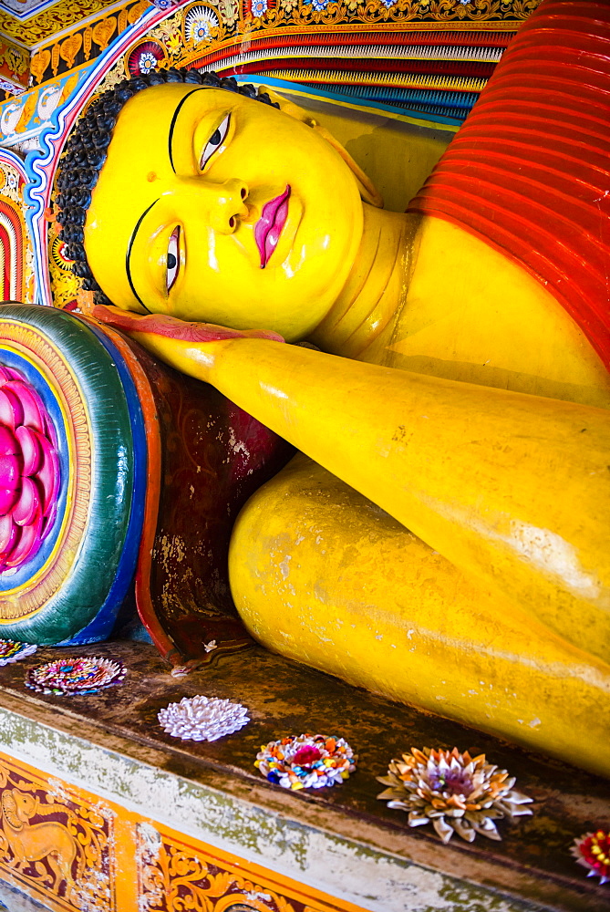 Colourful reclining Buddha statue at Isurumuniya Vihara, Anuradhapura, UNESCO World Heritage Site, Sri Lanka,Asia