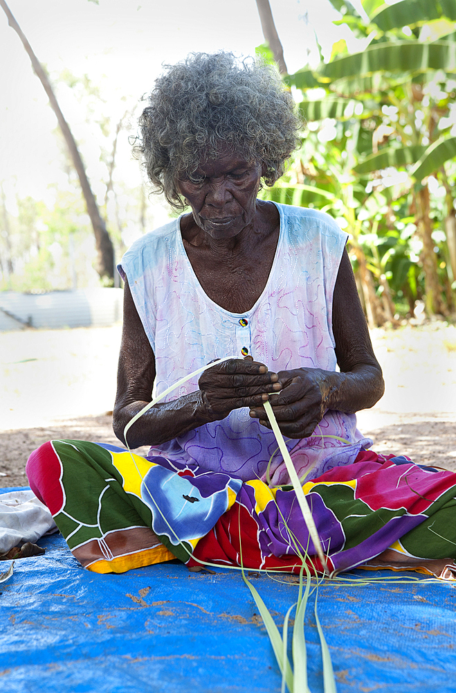 A woman, Aboriginal elder, weaving baskets, Nyinyikay Homeland, East Arnhem Land, Northern Territory, Australia, Pacific