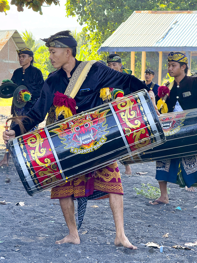 Ceremonial drummers coming to perform with their ornately painted drums on Sumbawa Island, Indonesia.