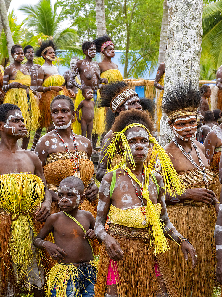 Females from the village of Uwus perform a greeting ceremony in traditional regalia, Asmat Region, Papua, Indonesia.