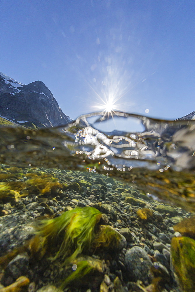 Above and below view of ice melt waterfall cascading down in Svartisen National Park, Melfjord, Nordfjord, Norway, Scandinavia, Europe