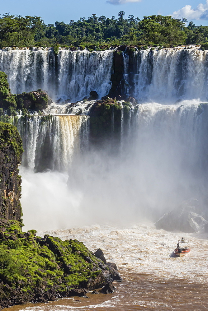 A river boat at the base of the falls, Iguazu Falls National Park, UNESCO World Heritage Site, Misiones, Argentina, South America